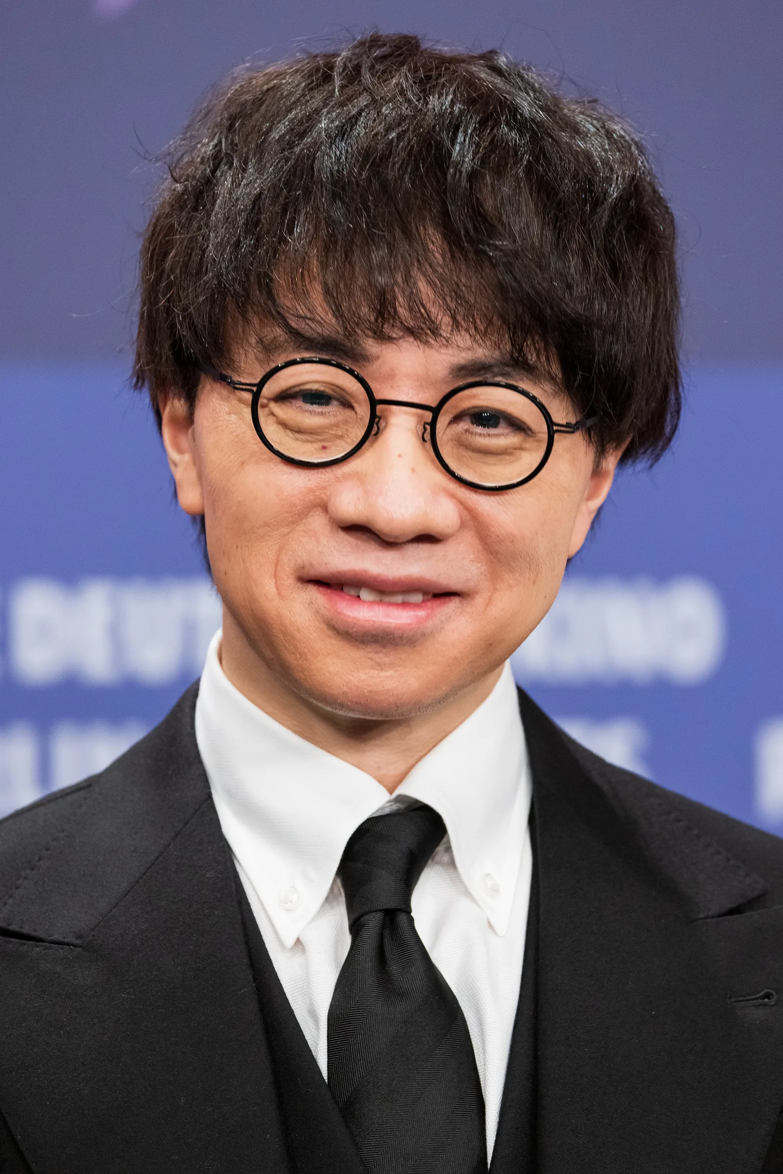 Makoto Shinkai seated during a Suzume press event at the 2023 Berlin International Film Festival