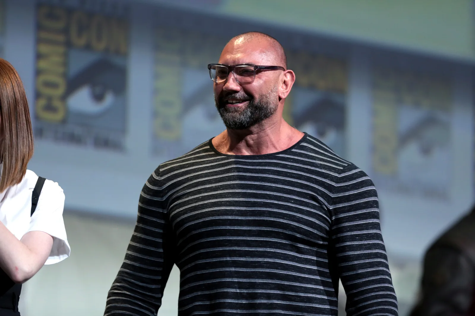 Dave Bautista smiling onstage at the Guardians of the Galaxy Vol. 2 panel during 2016 San Diego Comic-Con