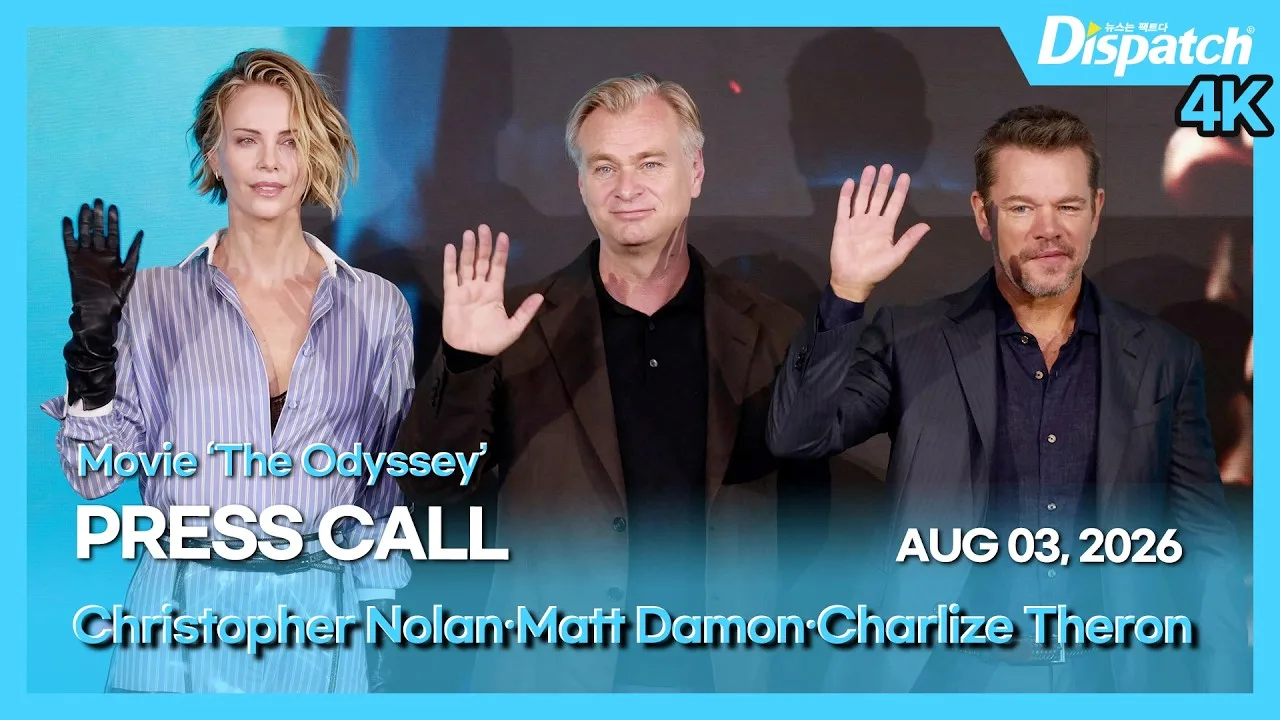 Charlize Theron in a striped shirt, black gloves and a transparent skirt beside Christopher Nolan and Matt Damon in Seoul