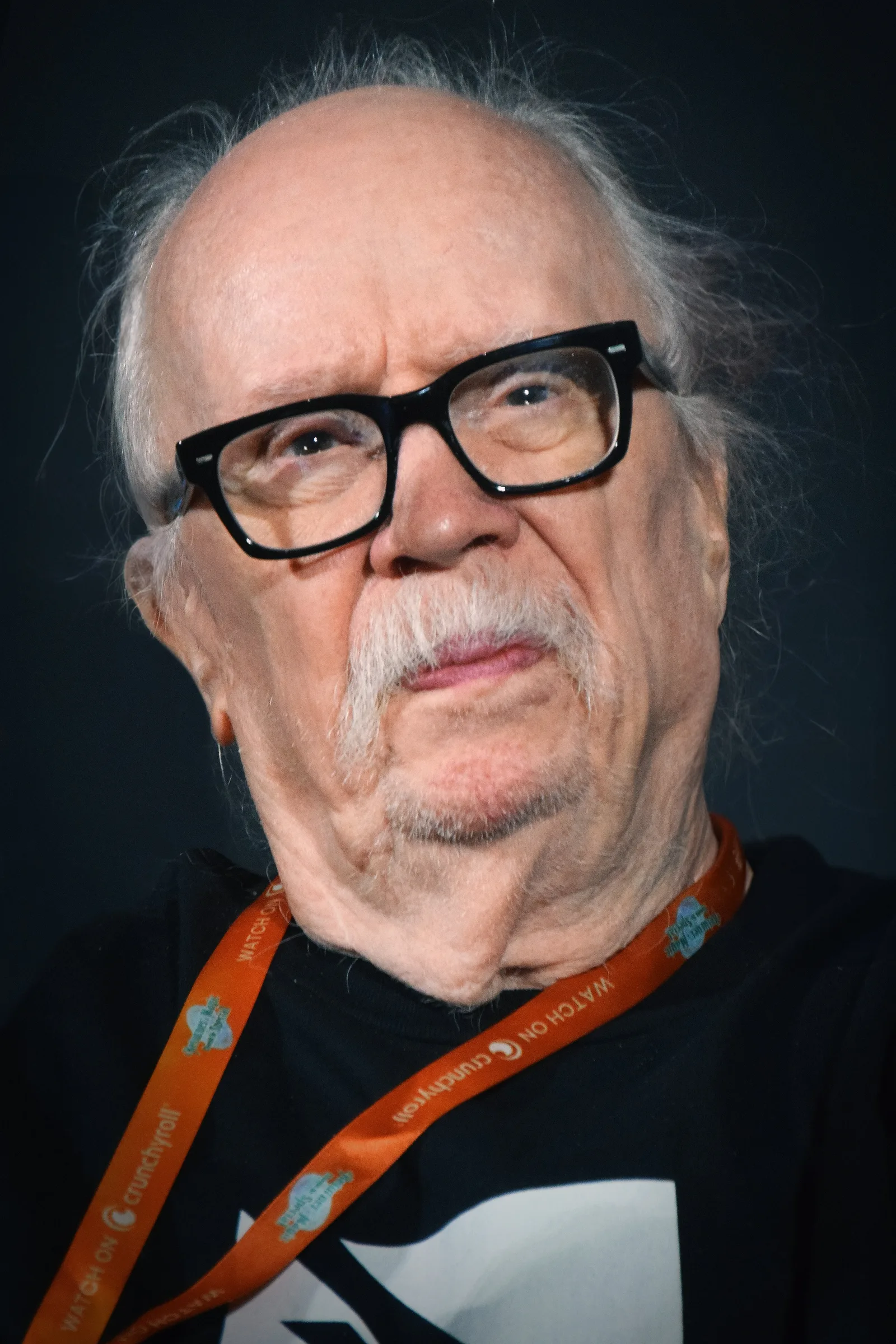 John Carpenter seated onstage at the 2023 New York Comic Con