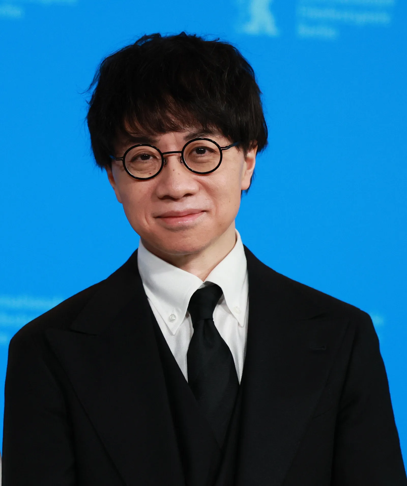 Makoto Shinkai speaking into a microphone at the 2023 Berlin International Film Festival