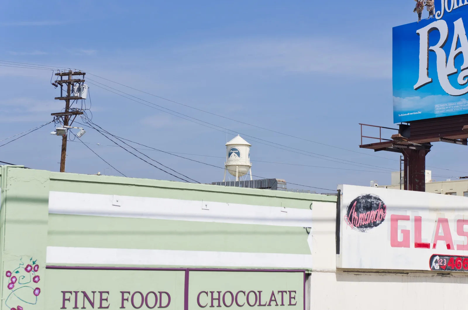 A Paramount Pictures studio building and water tower beneath a blue sky