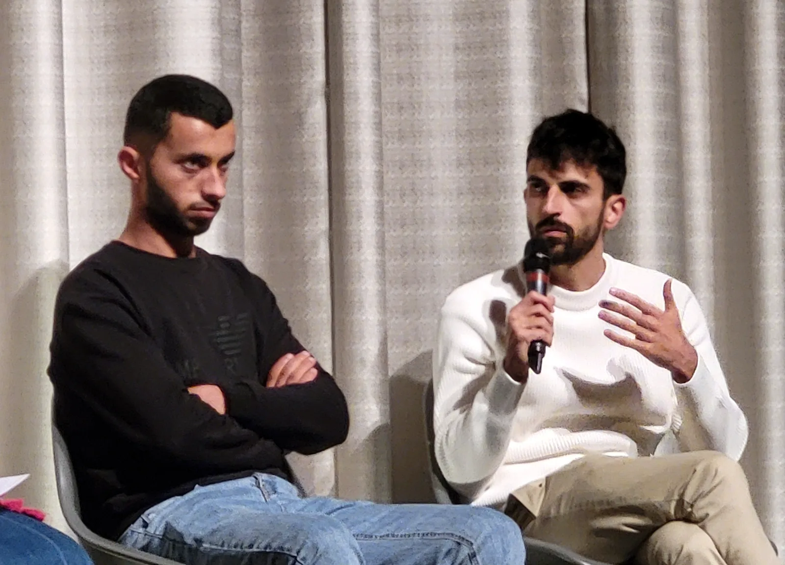 Palastenian political activist Basel Adra and Israeli journalist Yuval Abraham discussing their film No Other Land at Cinema Colosseum during the Berlin Film Festival.