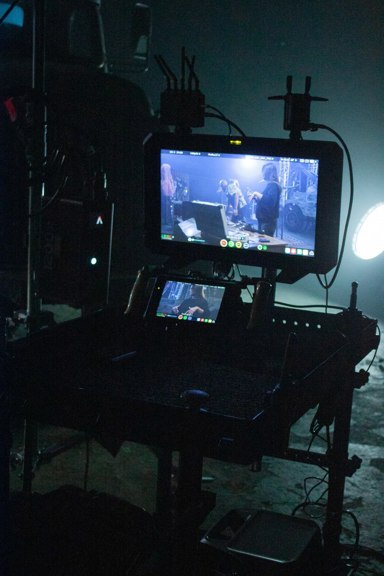 A camera set up for indoor filming, with its rig and lighting around it.