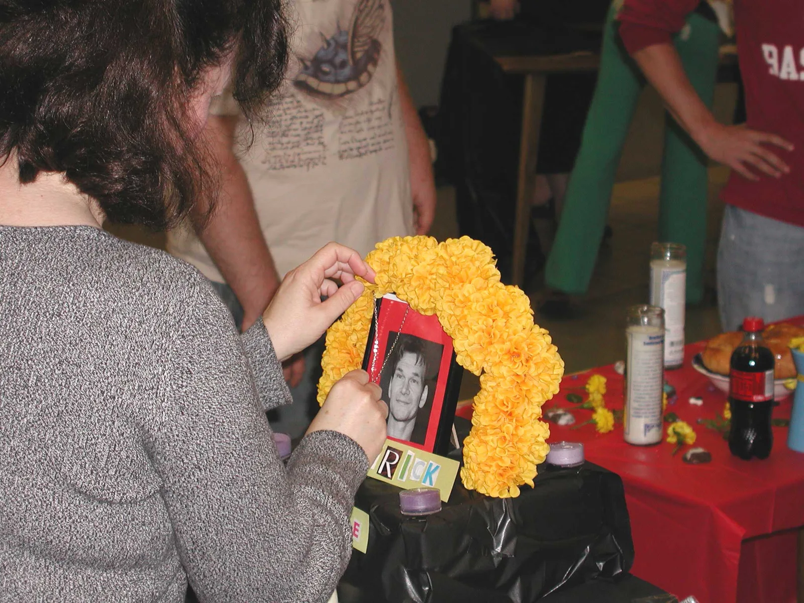 Day of the Dead setup, 10/23/09. A student puts a finishing touch on her' group's altar to Patrick Swayze.