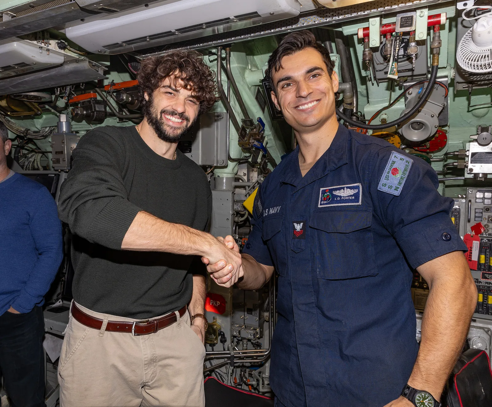 250210-N-GB594-10015 NORFOLK Actor Noah Centineo, from the show "The Recruit", left, poses for a photo with Electrician's Mate (Nuclear) 1st Class Ian Porter aboard the Los Angeles-class attack submarine USS Pasadena (SSN 752), Feb. 10, 2025. Actor Noah Centineo, creator Alexi Hawley, and executive…